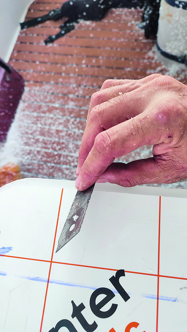 A blade being scraped around the edges of perspex