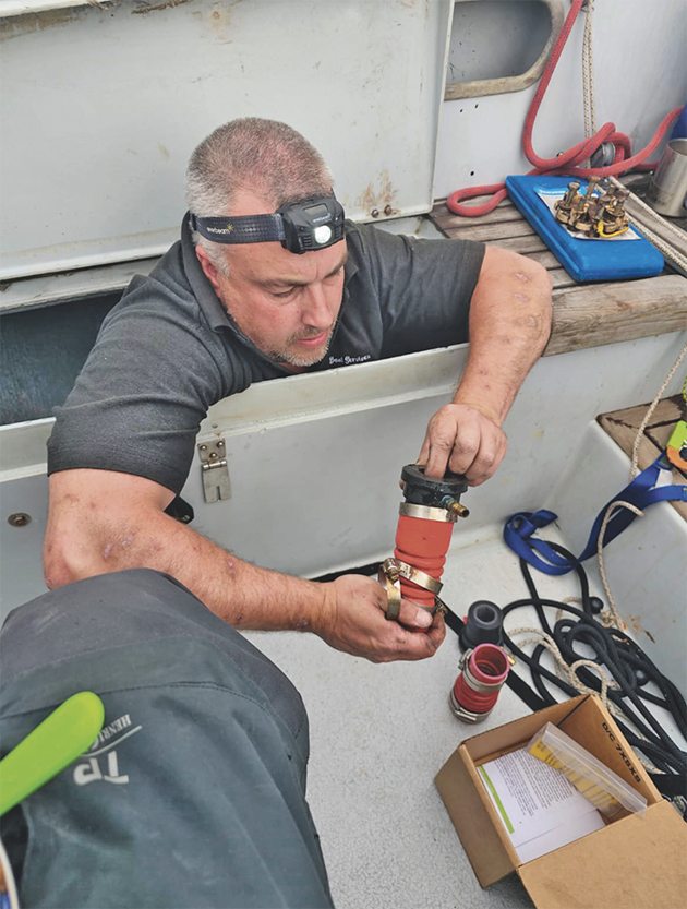 A man removing a boat shaft seal