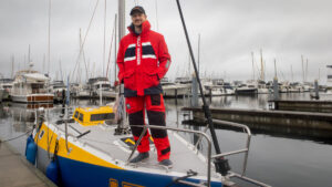Josh Kali, standing on the deck of his boat