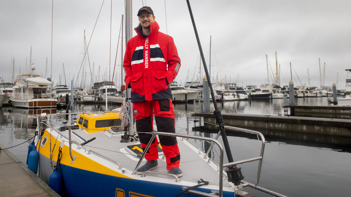 Josh Kali, standing on the deck of his boat