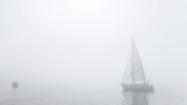 a yacht sailing in fog
