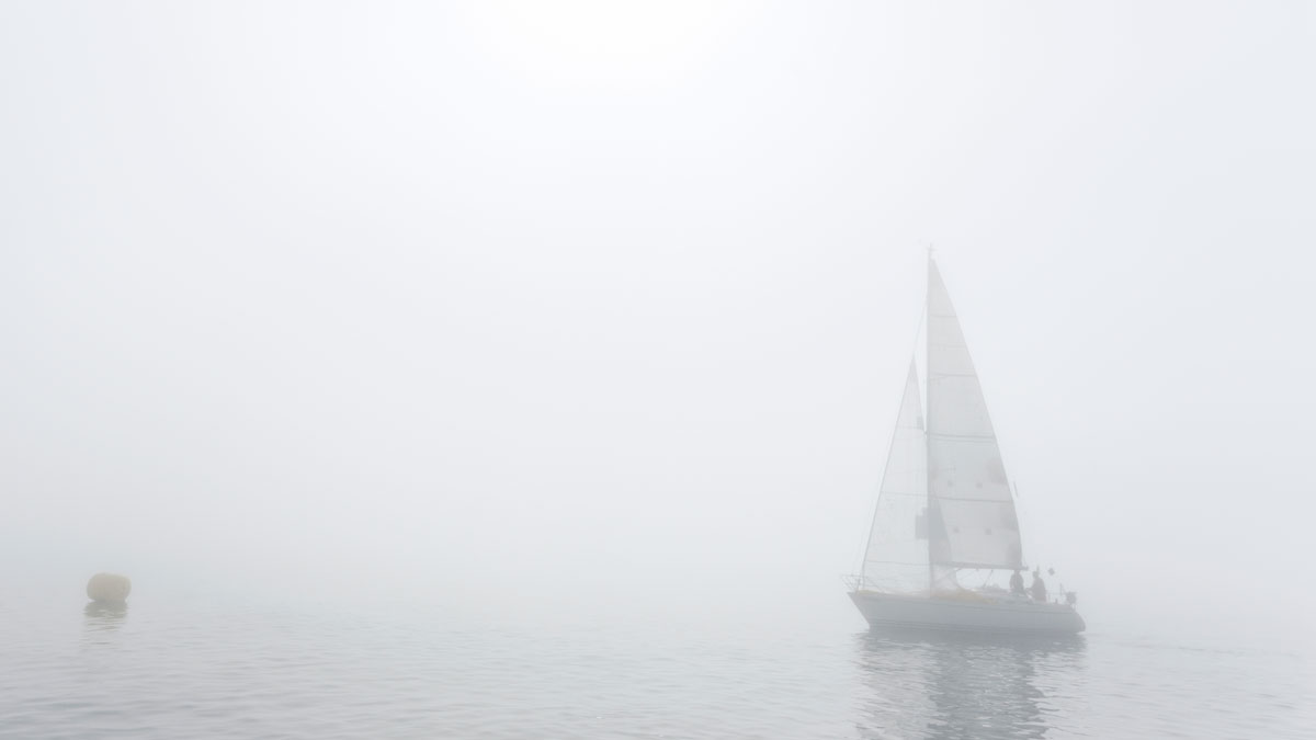 a yacht sailing in fog