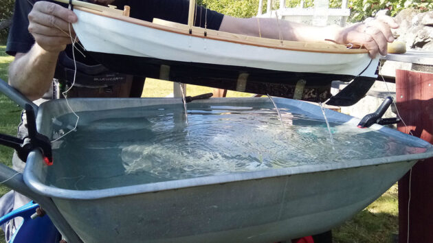 A model boat being tested in a tank to work out design of a new keel