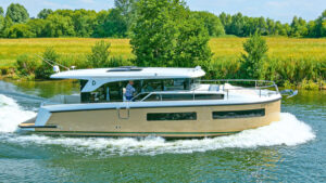 A delphia 11 boat motoring along a river