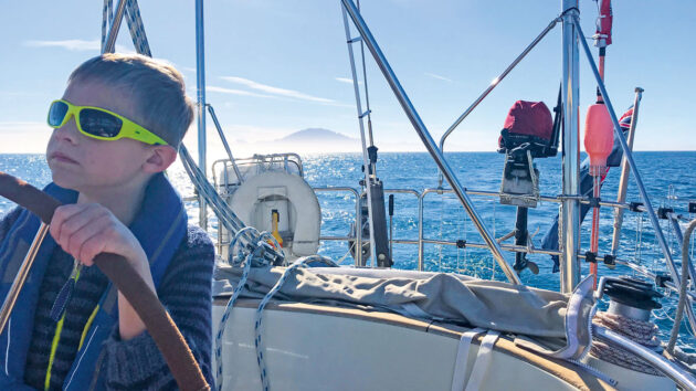 boy at the helm, sailing in the Med. Credit Antoni Mazur
