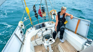 A woman solo sailing on a yacht