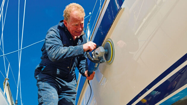 A man polishing the topsides of a boat