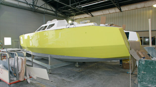 A boat on the hard with a mirror finish on its hull and topsides