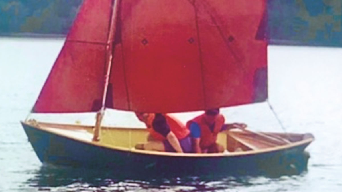 Two people sailing a Medway Doble