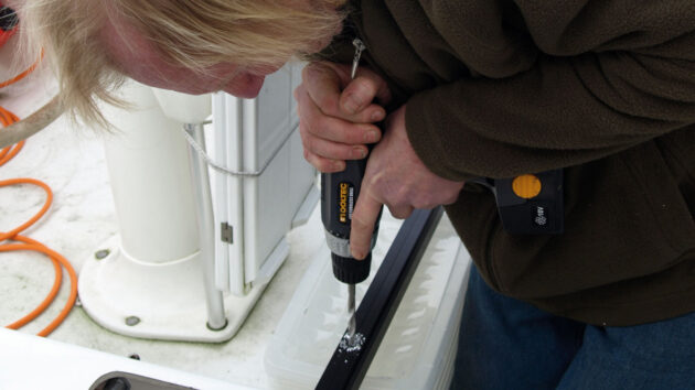 A man drilling on a boat