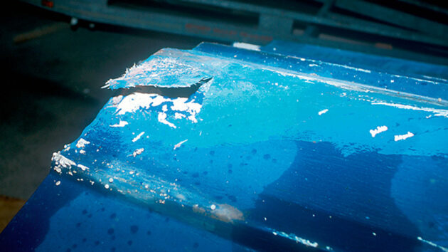 A rough patch of mat and resin peeled off easily but the hull seemed solid underneath