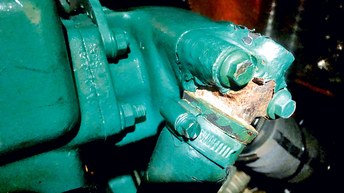 A rusty exhaust elbow on an engine