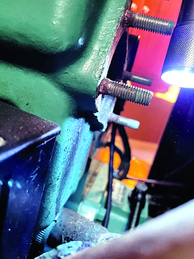 An exhaust elbow flange on a boat engine