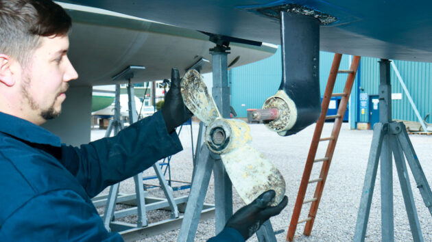 A man servicing a saildrive on a boat
