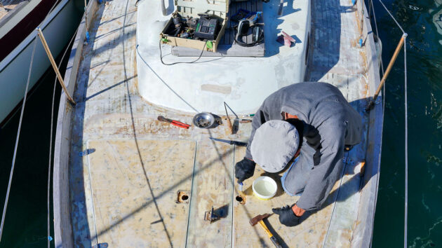A man working on the deck of a boat