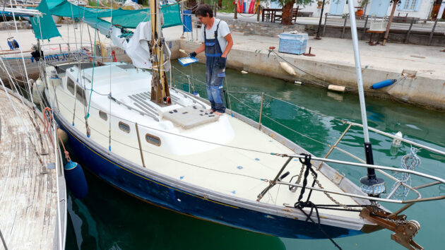 A man painting SoftSand antiskid on a boat deck