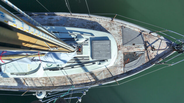 A boat with all of the teak planks removed from the deck ahead of laying SoftSand coating