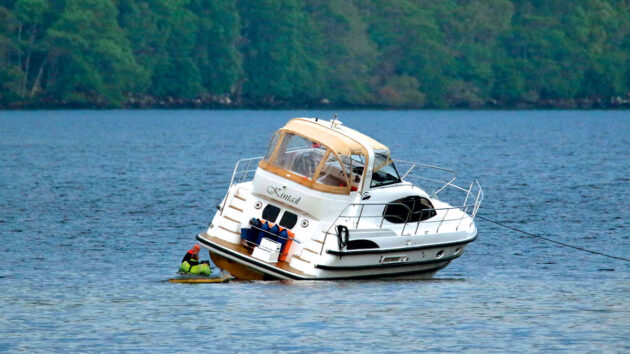 A motorboat after running aground in mud in a river