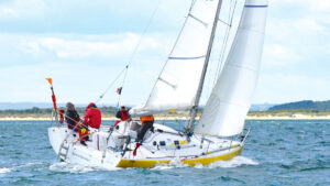 A Pogo 8.50 yacht being sailed along the coast