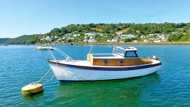 A boat tied to a mooring on a river