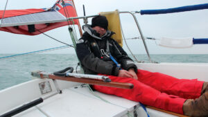A man sleeping while sailing shorthanded