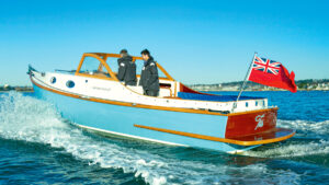 Two people aboard the Westons Point 27 motor launch