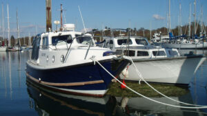 A boat secured using pile mooring pick up lines