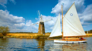 A boat sailing on the Broads during an inland charter holiday