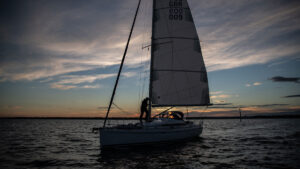 A person night sailing on a yacht