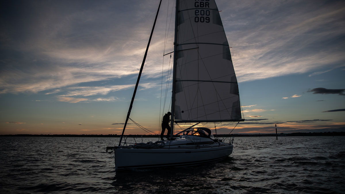 A person night sailing on a yacht