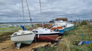 Abandoned boats and end-of-life vessels on the shore-line at Eastney –where 118 abandoned boats have been removed since 2022. Credit: Langstone Harbour