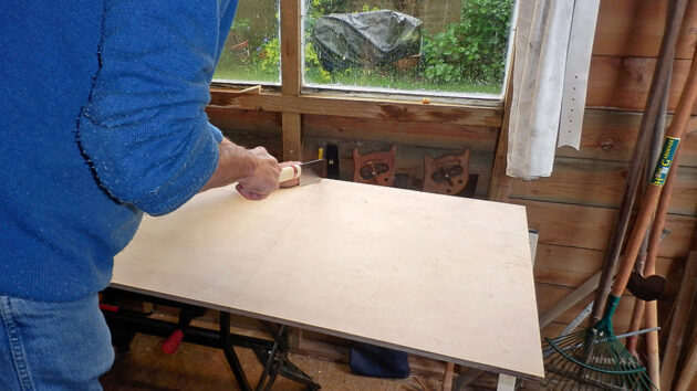 A man cutting plywood