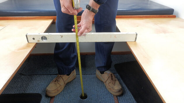 A man measuring for a boat berth
