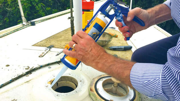 A man using marine sealants on a boat