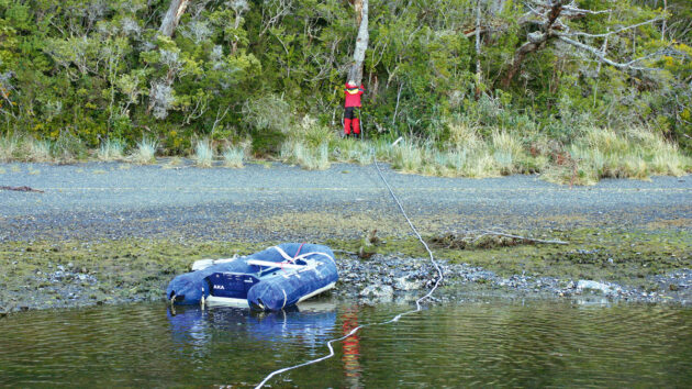 A person tying a shore line for a yacht