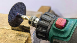 A man using a grinder to sharpen multitool blades