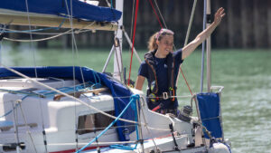 Solo sailor Jazz Turner, first disabled person to complete a non-stop, unassisted circumnavigation of the UK and Ireland, smiles at the voyage finish at Brighton Marina. Credit: Fergus Kennedy