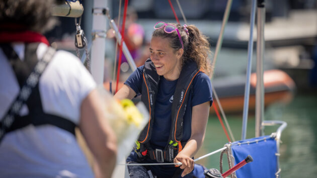 Solo sailor Jazz Turner, first disabled person to complete a non-stop, unassisted circumnavigation of the UK and Ireland, smiles at the voyage finish at Brighton Marina. Credit: Fergus Kennedy