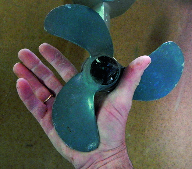 A person holding a right-handed propeller in their hand