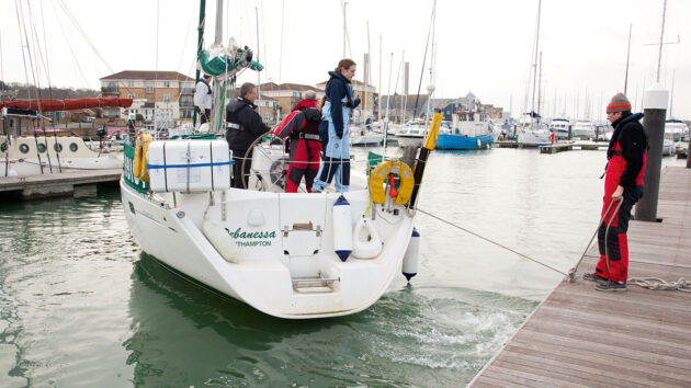 A yacht turning in a marina