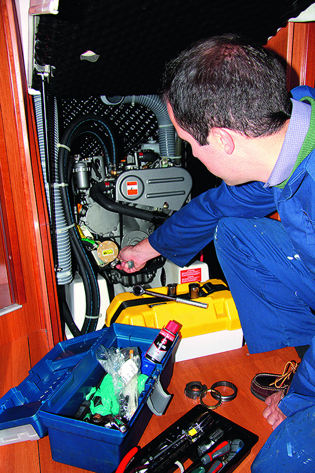 A man servicing an engine before sailing offshore