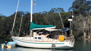 A boat fitted with a sail cover anchored