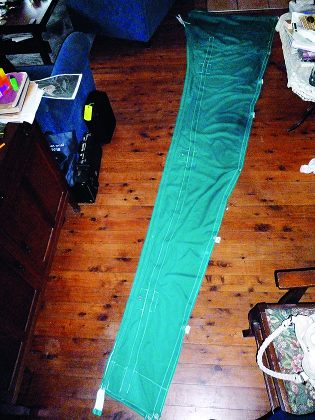 A sail cover laid out on the floor