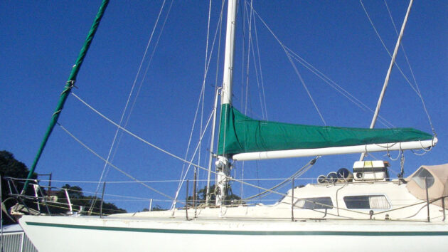 A green sail cover on the mainsail of a yacht