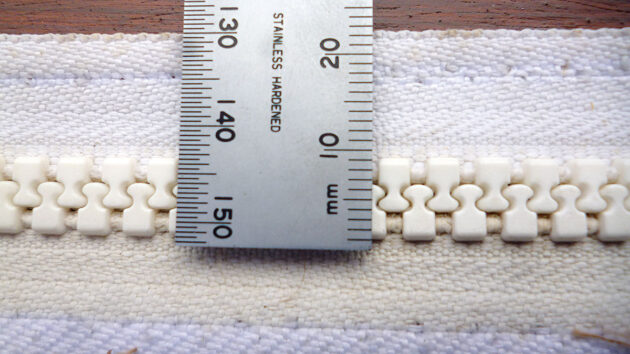 A tape measuring measuring a zip