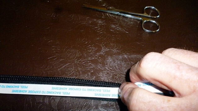 double sided sticky tape being used to hold a zip in position before sewing