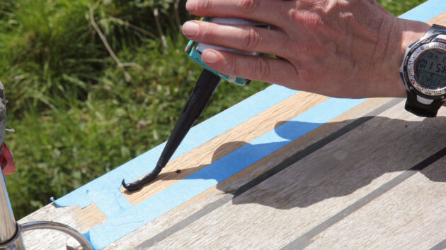Masking tape being stuck on a boat