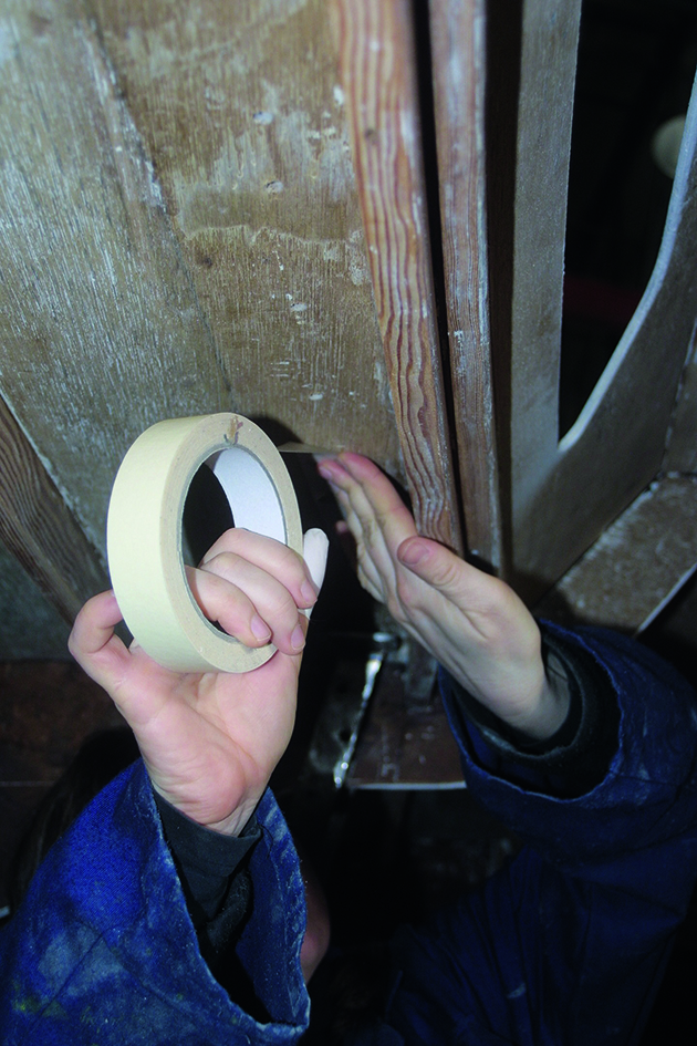 Masking tape being applied to a boat to prevent drips when fitting deck fittings