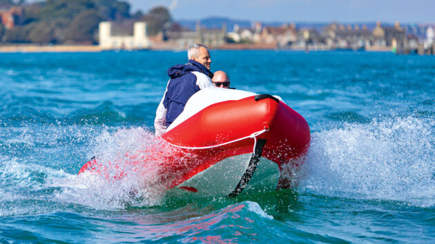 A man on a SpearFish 520 inflatable boat in a harbour