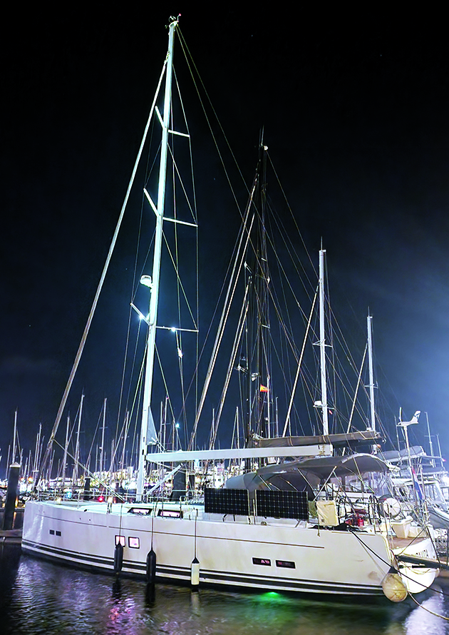 A Hanse 588 yacht moored in a marina at night